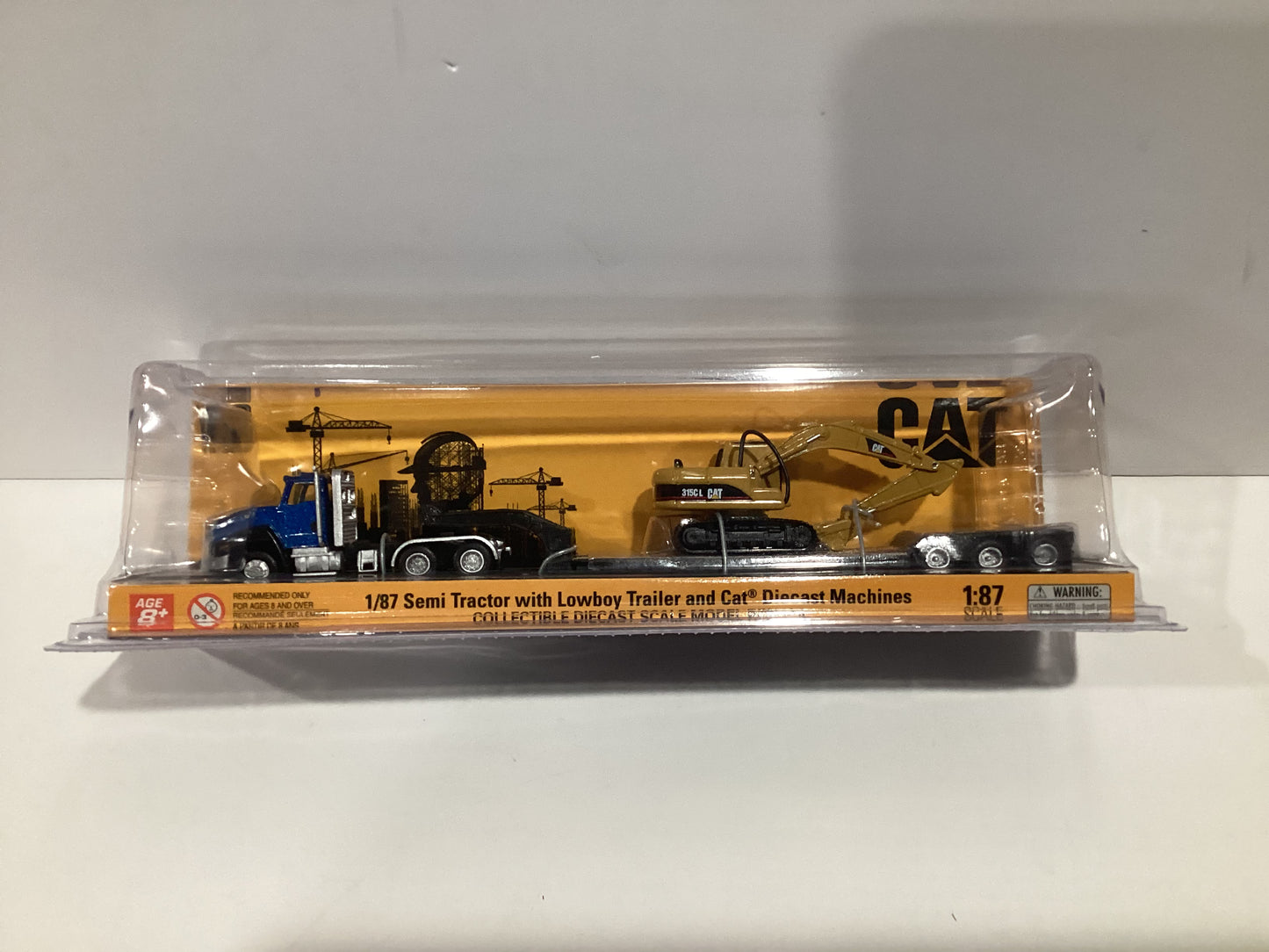 Diecast Masters 1/87 CAT Semi Tractor with Lowboy Trailer and Cat Diecast Machines- Blue Cab