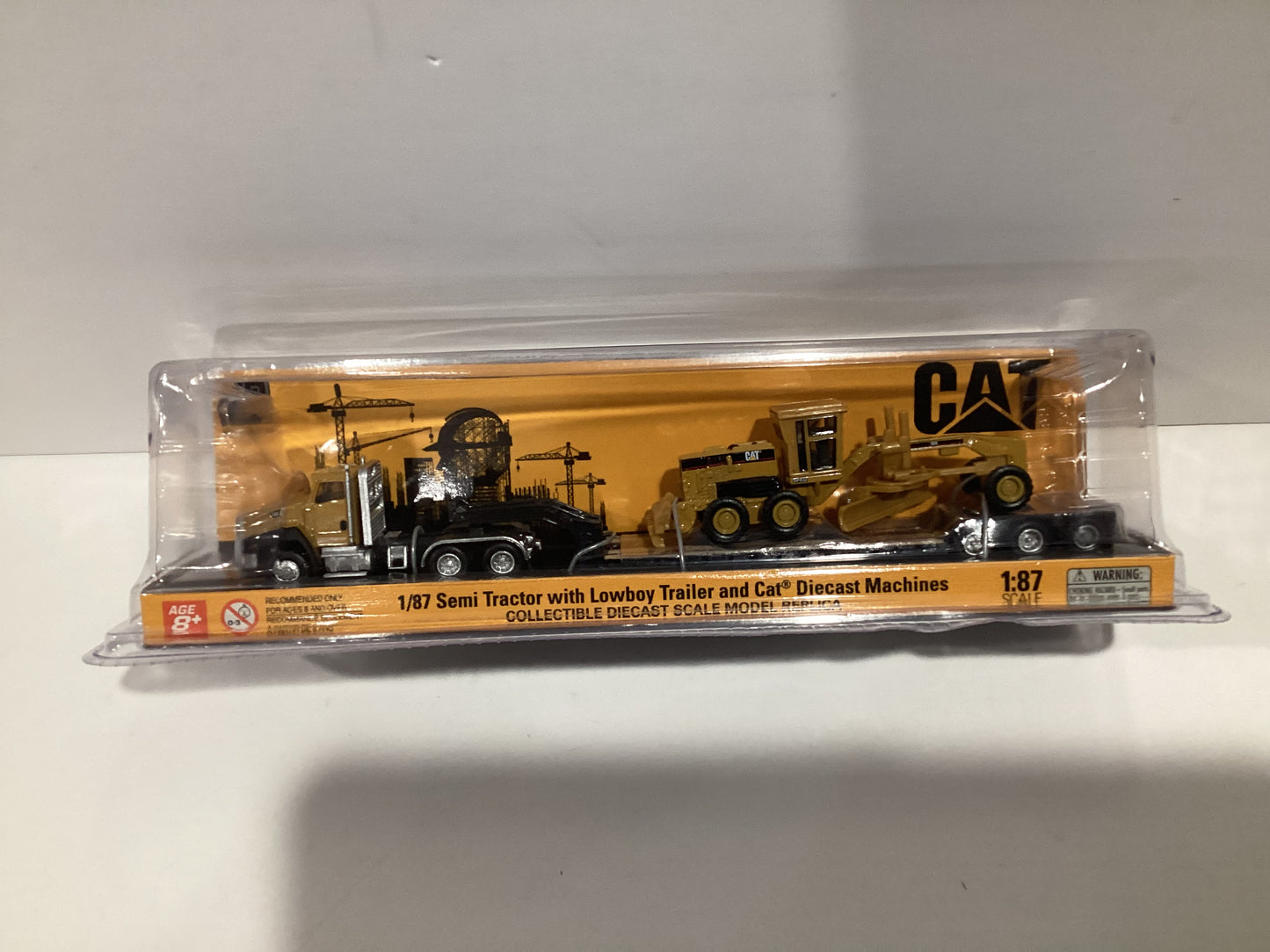 Diecast Masters 1/87 CAT Semi Tractor with Lowboy Trailer and Cat Diecast Machines- Yellow Cab